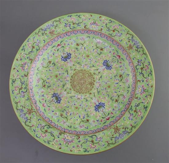 A Chinese lime green ground footed dish, Daoguang seal mark and of the period (1821-1850), D. 25.5cm, section of rim broken and re-stuc